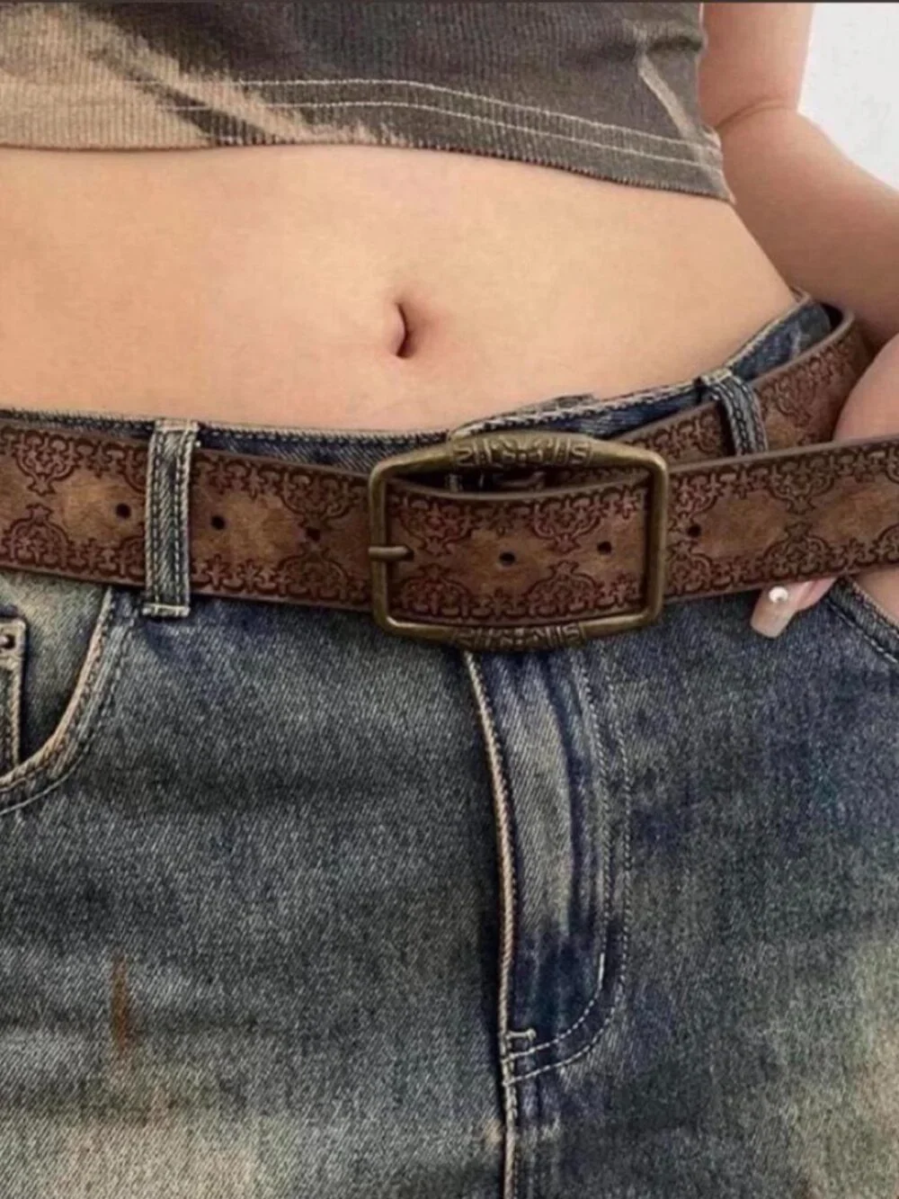 brown belt with embossed floral and scrollwork design